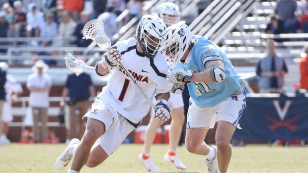 Connor Shellenberger dodges with the ball during the Virginia men's lacrosse game against Johns Hopkins at Klockner Stadium.